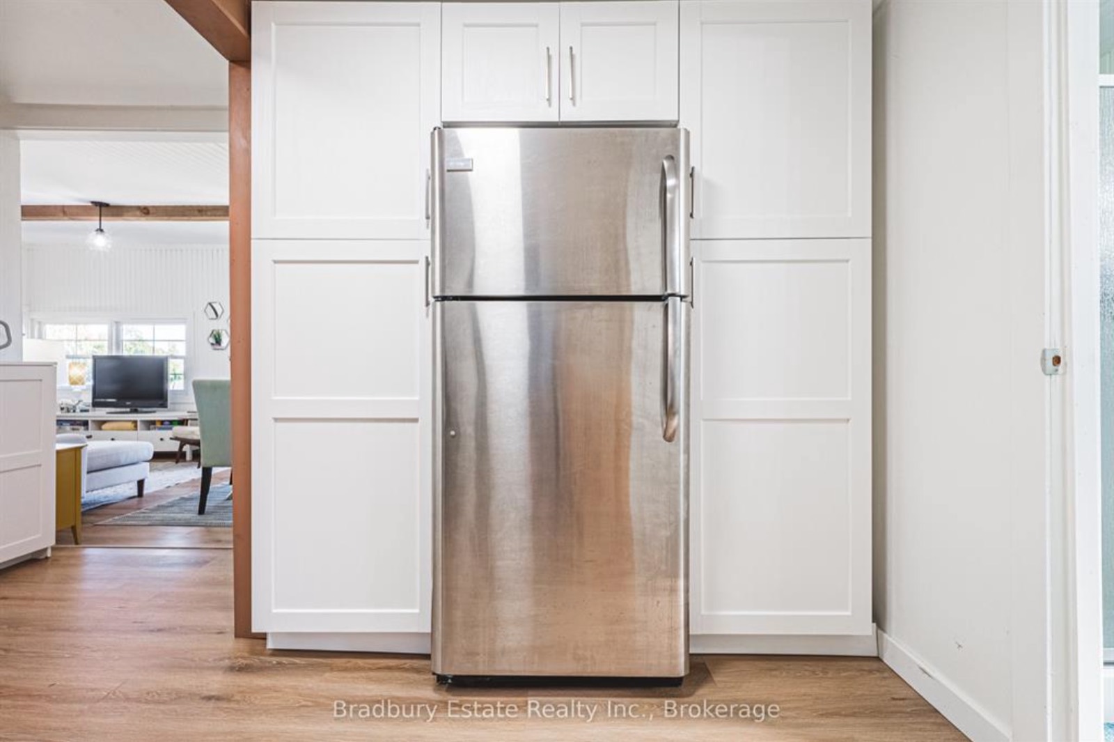 Fridge built into a wall of white pantry cupboards