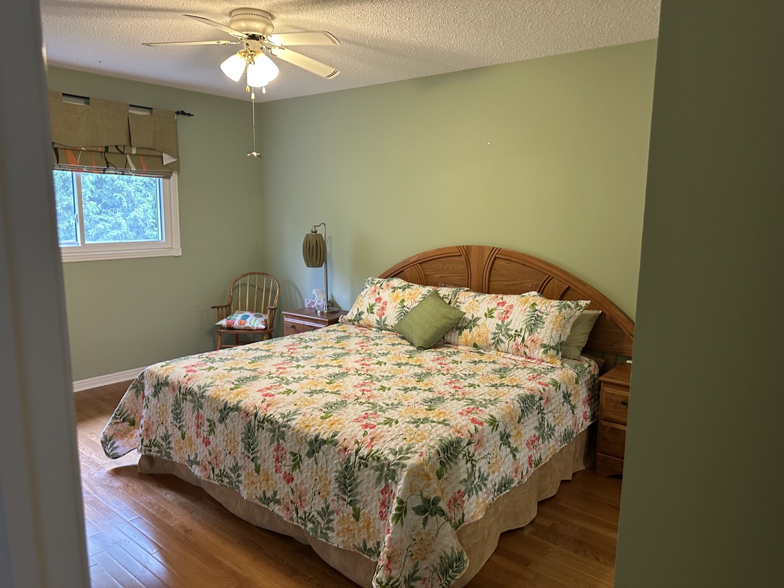 Green bedroom before, floral bedding