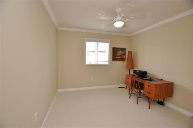 Bedroom before: yellow walls, ceiling fan, a desk