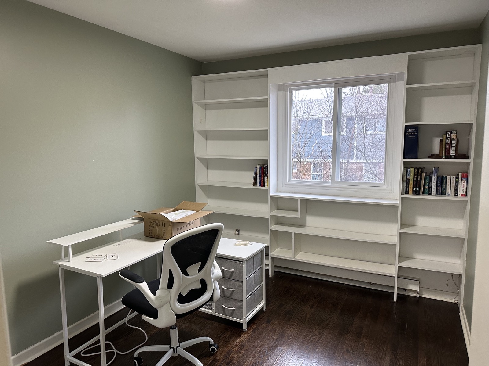 Spare room before, white shelving and a desk