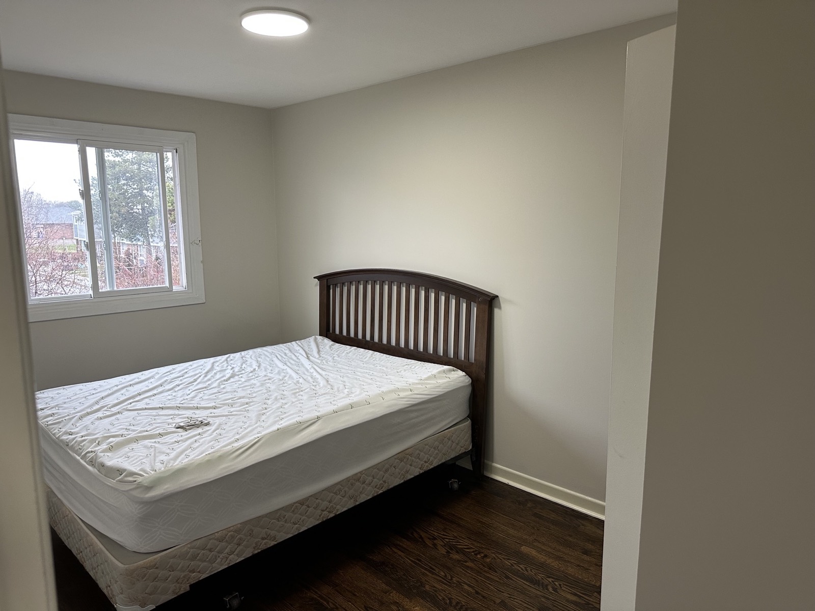 Bedroom before, a bare bed and empty walls