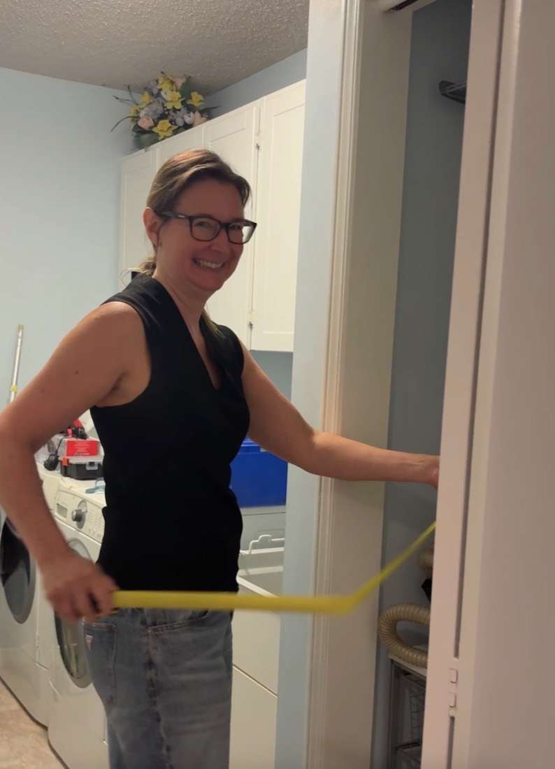 Working on a cabinet door in a kitchen